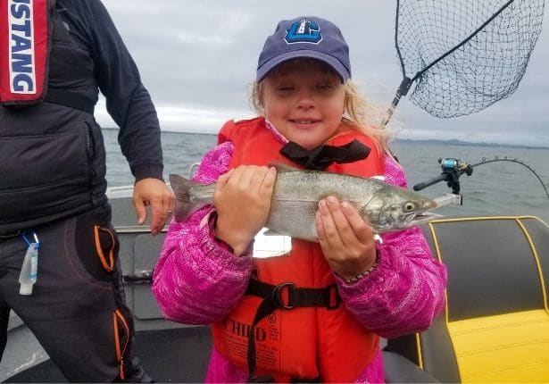 Cute little girl with salmon catch