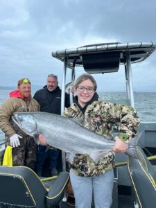 Girl with a big fish she just caught in Astoria, OR